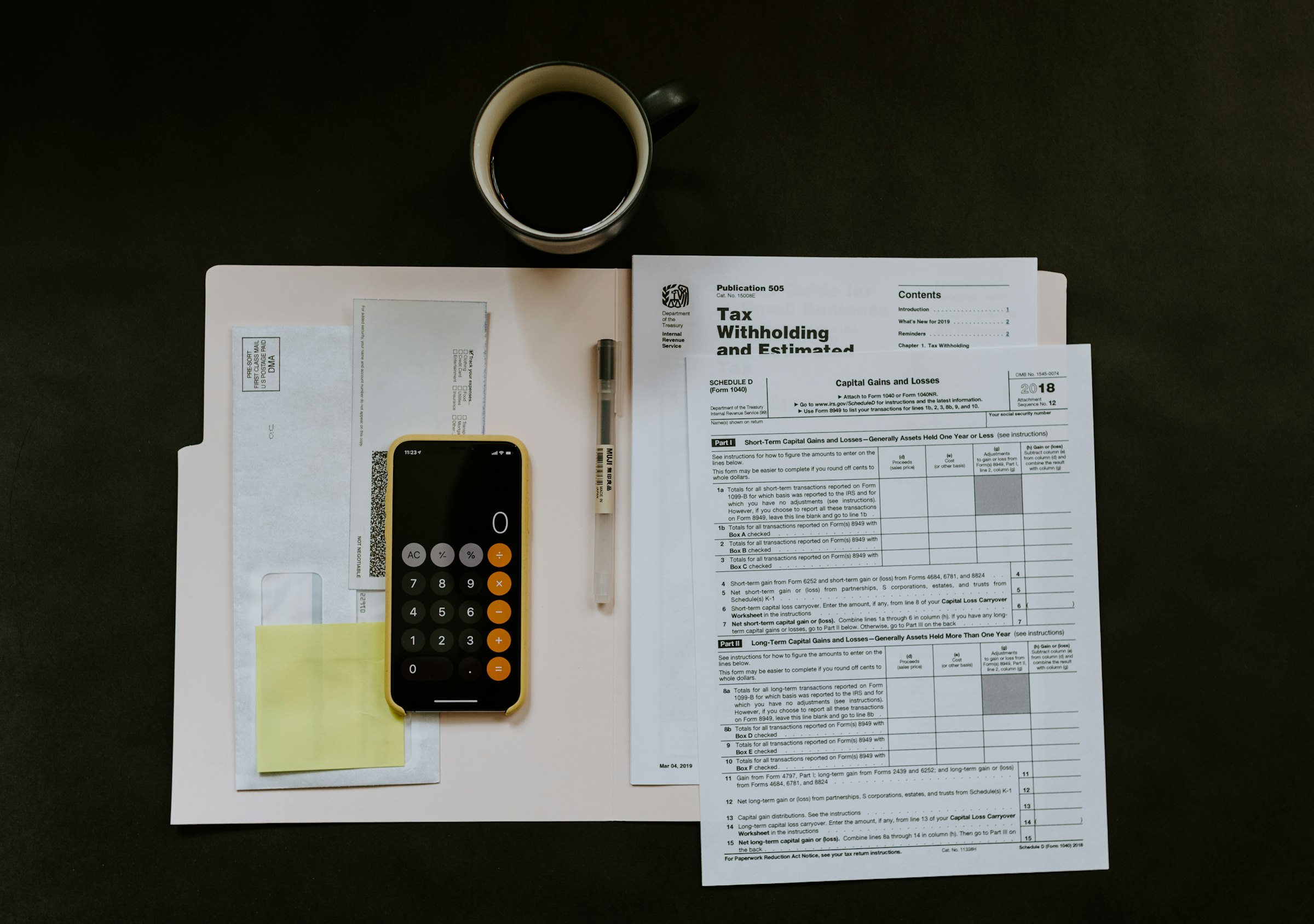 Person reviewing financial documents and bills at a desk