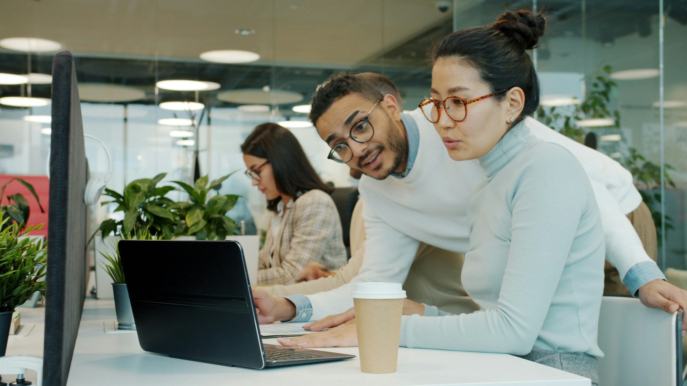 Two colleagues reviewing a screen in the office